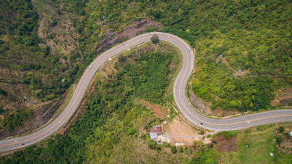 Asphalt road on the hill in Phetchabun province, Thailand. Aerial view from flying drone.