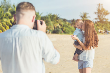Father, Mother and Kid with relax activity, walking and playing on the tropical beach