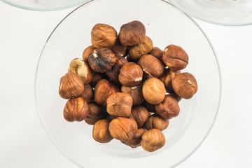 roasted peanuts isolated in glass bowl, on white background