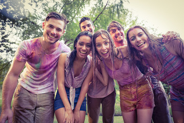 Happy friends covered in powder paint