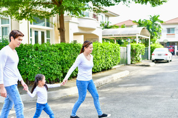Parents and daughters go for a walk in the park.