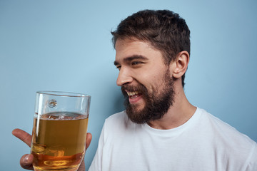 man smiling with a beer on a blue background