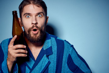 man with beer on a blue background