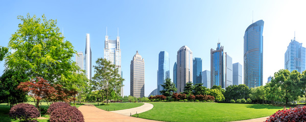 city park with modern commercial building background in shanghai - obrazy, fototapety, plakaty