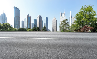 Fototapeta na wymiar empty asphalt road with city skyline background in shanghai,China