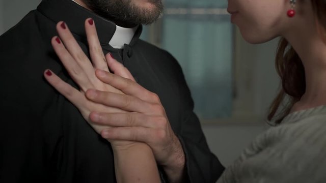 sinners, religion: young priest gives in to the advances of a sexy woman