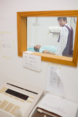 Obraz premium View of doctor doing a radiography through a window