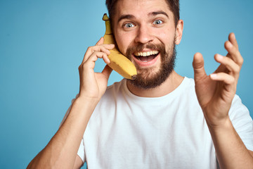 man with a banana in his hand, a happy look, a beautiful smile