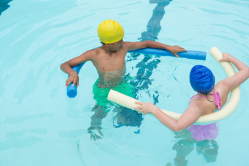 Two kids swimming in pool