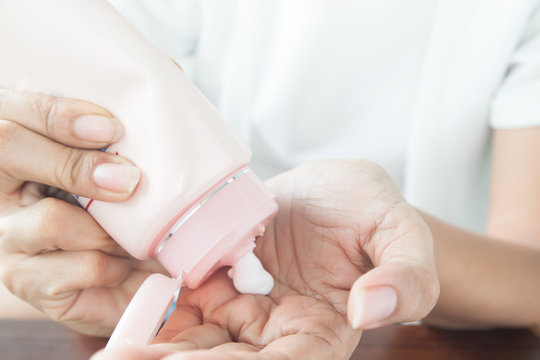 Woman applying lotion on her hand, Beauty concept