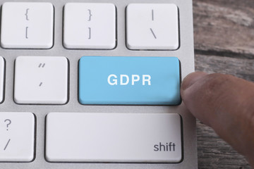 Close up of finger on keyboard button with GDPR  word.