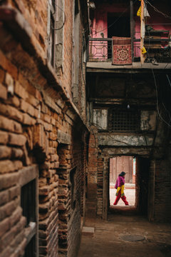 Woman wearing red traditional clothes in old city Bhaktapur, Nepal