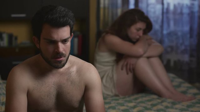  male impotence: upset couple in bed