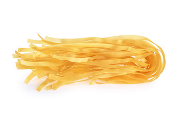 Fettuccine pasta isolated on white background. Raw.