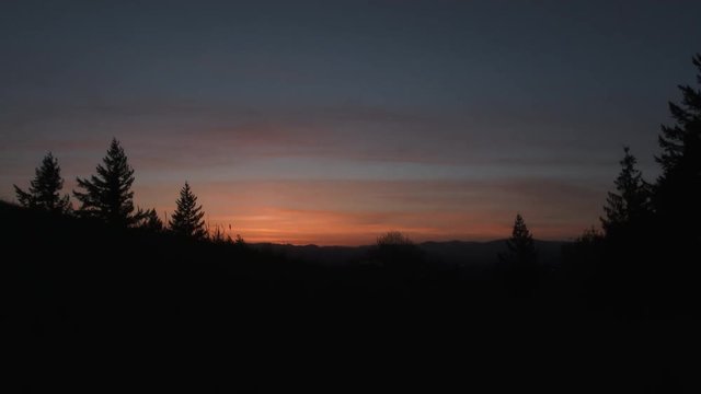 Sunrise time lapse night to day over the Willamette Valley in Oregon and Washington from hillside on clear morning, wide angle.