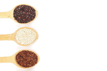 Black red white quinoa and chia seeds in wooden spoon isolated on white background with copy space for your text