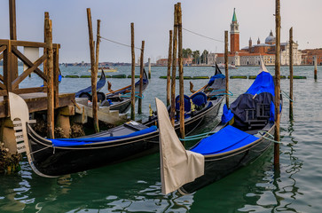 Fototapeta na wymiar Gondolas along Grand Canal at St Marco square with San Giorgio Maggiore church in Venice Italy