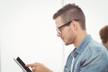 Man with eyeglasses using digital tablet 