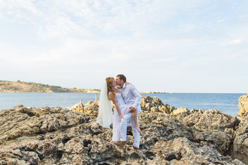 Bride and groom by the sea on their wedding day