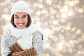 Brunette in warm clothing against light glowing dots design pattern