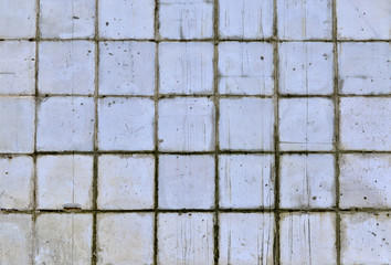Part of the wall of blue and white tiles of the old building.