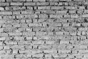 Part of the wall of brick pieces of an old building for demolition. Black and white image.