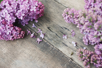 Spring flowers. Purple Lilac flowers Frame on Rustic Textured Gray wooden background. Top view, flat lay