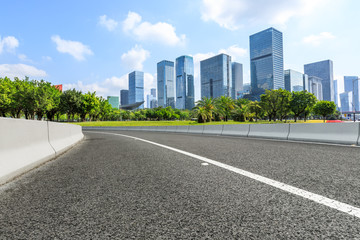 empty asphalt road and modern commercial office buildings