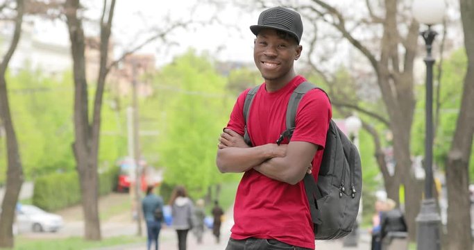 African american man portrait, student smiling with arms crossed
