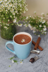 Blue Cup of Coffee Milk Latte Drink Cinnamon Sticks Wooden Background Rustic Camomile Flower Buquet Flat Lay