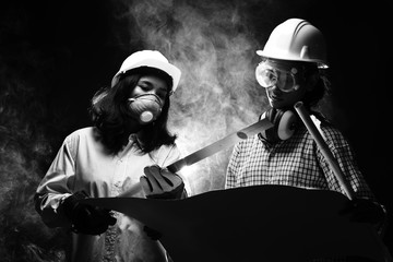 Two Beautiful Asian Architect Engineer women in hard hat, protector glasses goggle mask ear muff