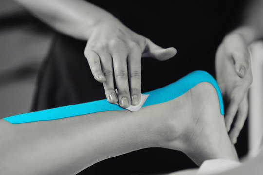 Achilles Tendon Treatment With Blue Kinesiology Tape