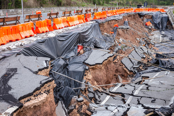 Big damage of asphalt road on the hillside cause of heavy rain and sliding earth