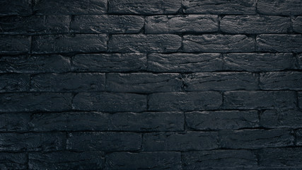 Black brick background. Top view. Copy space.