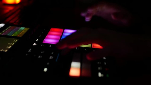 Skilled musician playing on digital audio workstation beatmaker groovebox maschine in studio