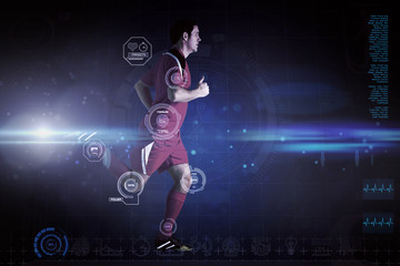 Obraz premium Football player in red running against blue dots on black background