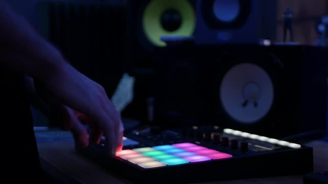 Producer making music with digital audio workstation sampler beatmaker in studio