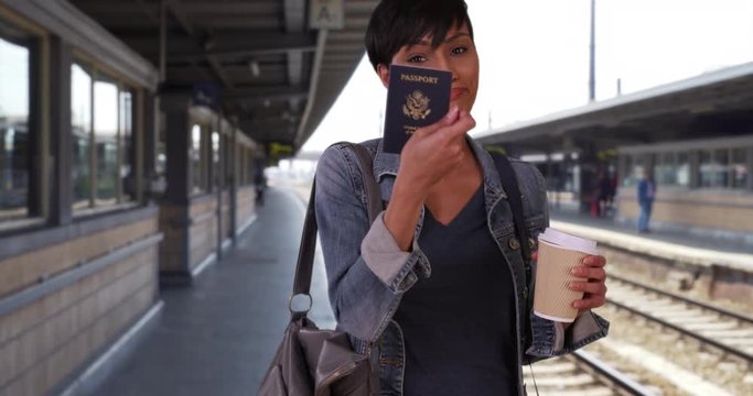 Short-haired young black female drinking coffee while waiting for her train finds her passport in her bag, Pretty black woman looking through her purse finds her lost passport and puts it back, 4k
