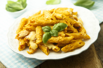 Pasta with creamy pumpkin sauce and fresh basil