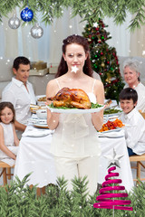 Mother showing turkey for Christmas dinner against twinkling stars