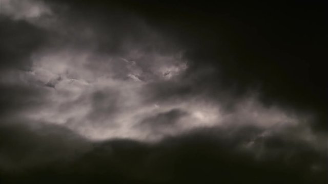 Time-lapse black clouds thickening and filling frame 
