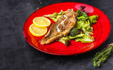 Steamed snapper (pacific ocean perch, sea bass, ruby perch) with soy sauce, lemon, ginger and parsley in Asian style. Healthy cooking