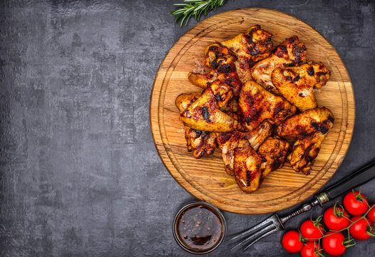 Grilled or oven roasted chicken wings glazed with barbecue sauce
