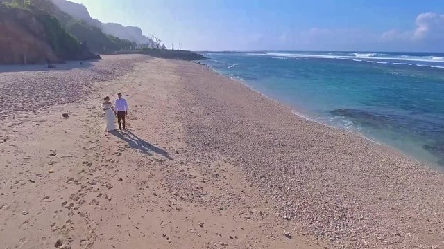 Aerial view Drone Footage 4K Happy couple beach in Bali.