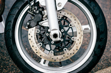 Motorcycle wheel with disk brakes system and metal spokes. Closeup detailed photo of motorbike...