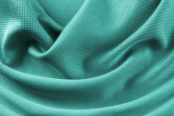 Naklejka premium Türkiser Stoff seidige Gewebe Struktur Glanz Stoff Material Textur mit Falten Macro Closeup Hintergrund