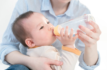 Mother is feeding the baby, white background