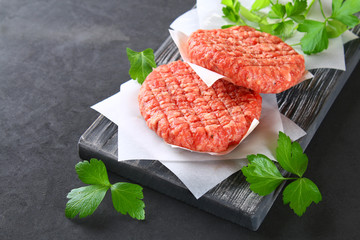 Raw minced meat for home made grill burgers cooking with spaces and herbs.