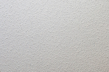 Texture of plastered single-colored gray wall with small dots