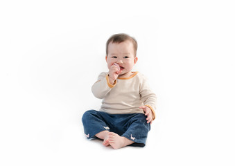 The baby is playing on the floor, the white background